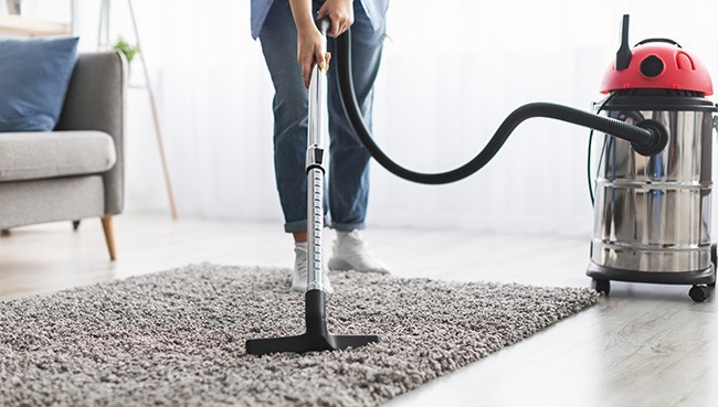 Young casual lady using vacuum cleaner | Blair Mill Outlet